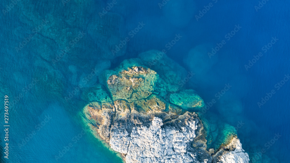 Aerial photo above rock reef crystal clear blue sea water