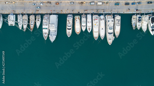 Fotografie Aerial view of a lot of white boats and yachts moored in marina on a turquoise water, during a summer season