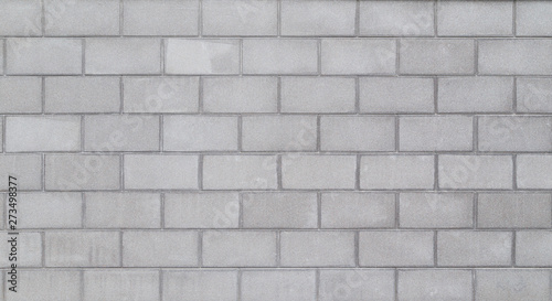 High resolution full frame background of a wall or building exterior made of light gray concrete blocks. Copy space.