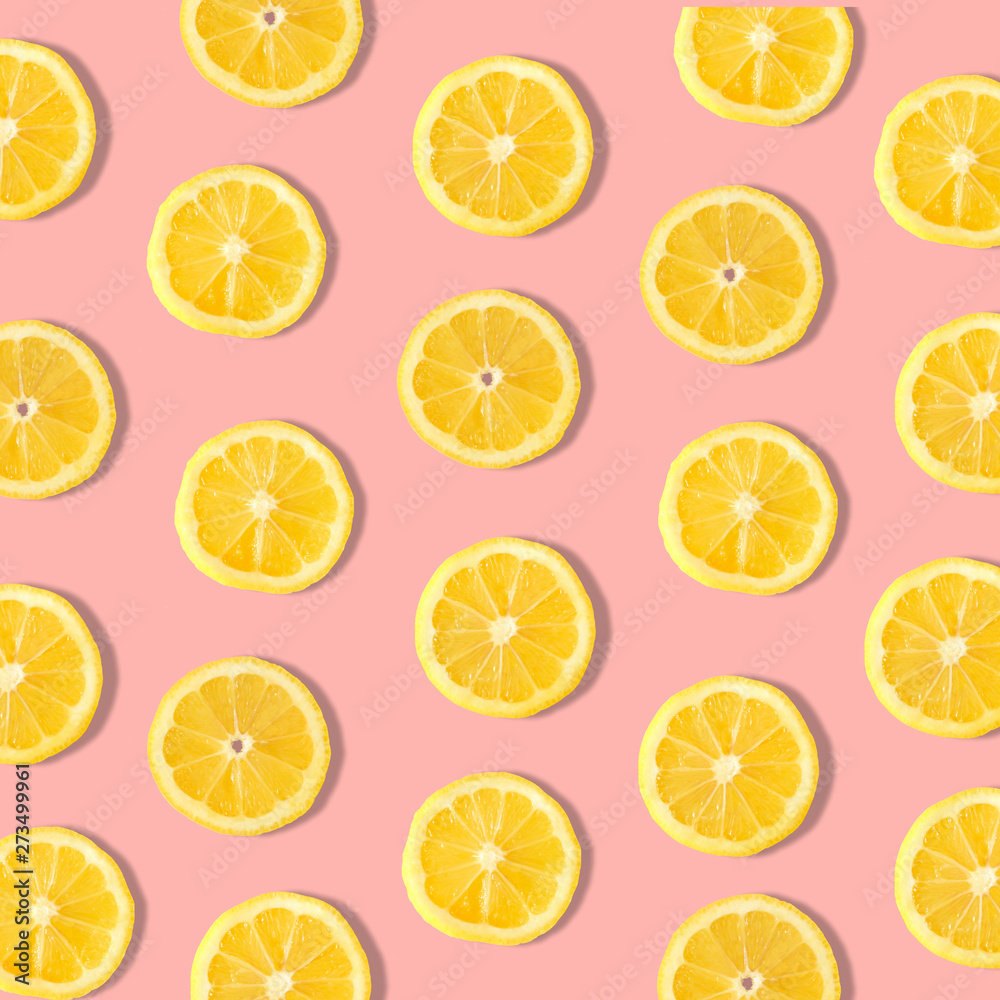 Summer fruit pattern of lemon slices on a pastel pink background