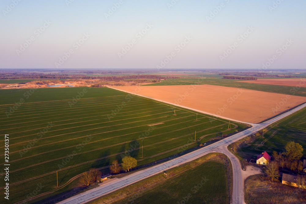 Roads and fields in evening light.