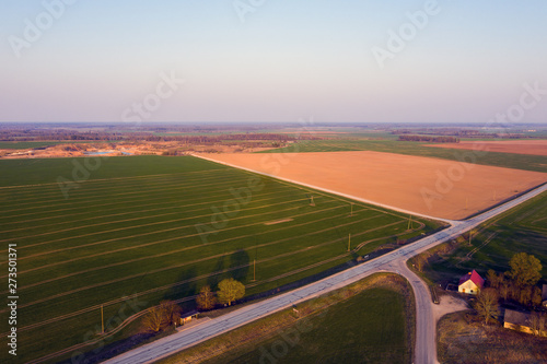 Roads and fields in evening light.