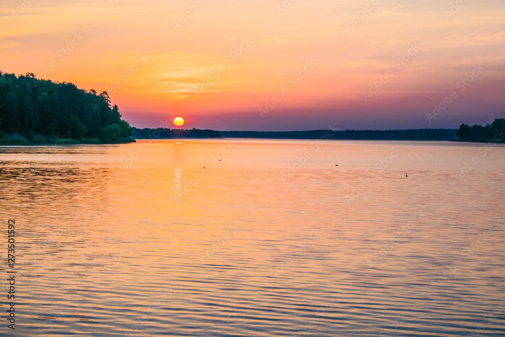 Sunrises sunsets on a summer pond in the forest