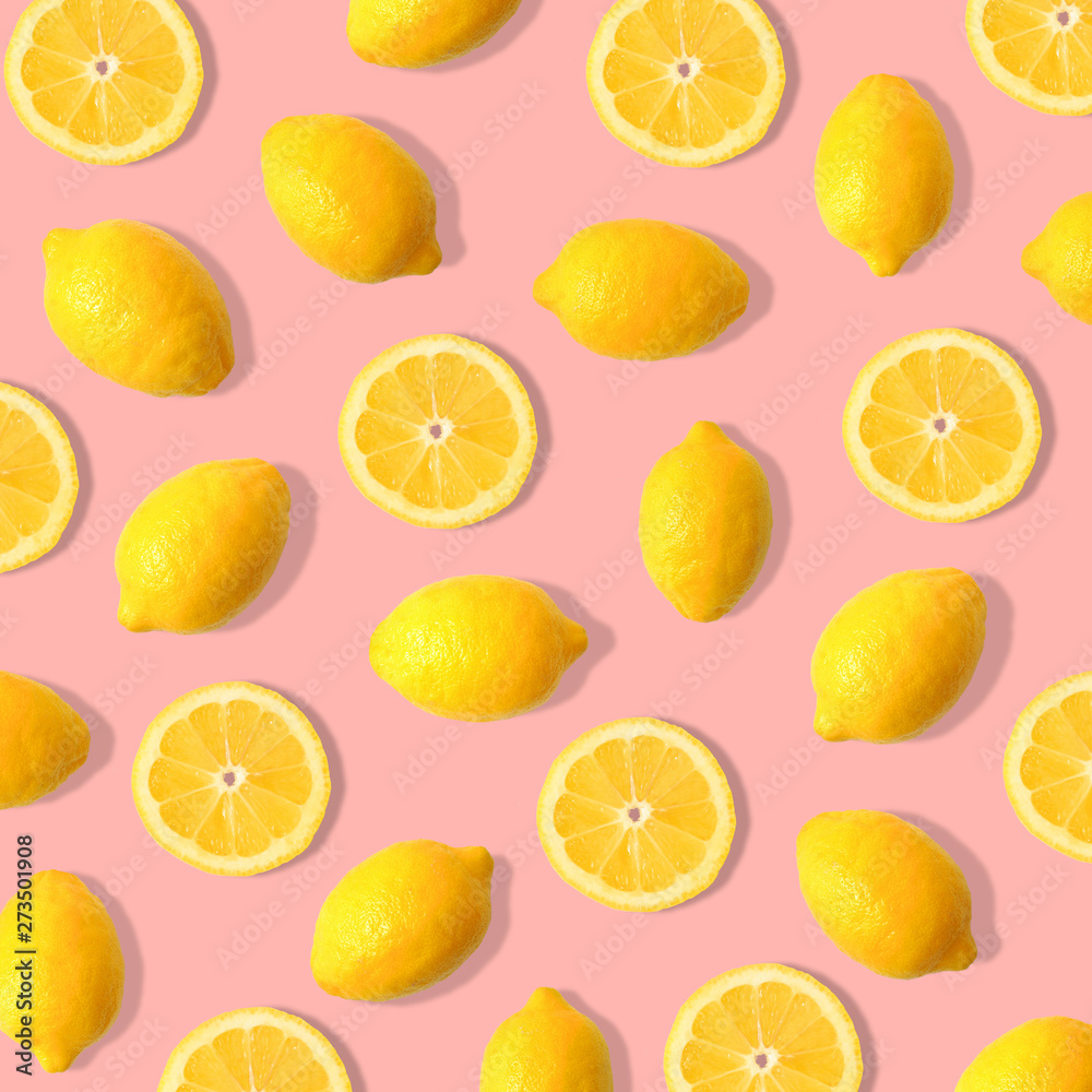 Summer fruit pattern of lemons and lemon slices on a pastel pink background