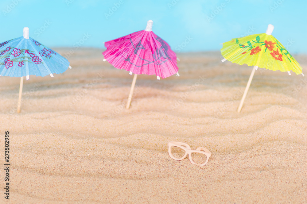 Umbrellas on the sandy beach. Tropical vacation background. Copy space, top view. Umbrellas on the sandy beach. Tropical vacation background. Copy space, top view.
