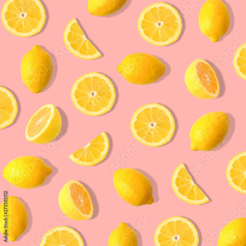 Summer fruit pattern of lemons and lemon slices on a soft pink background