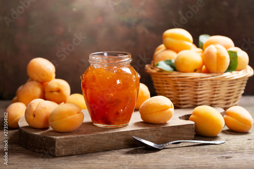 glass jar of apricot jam with fresh fruits
