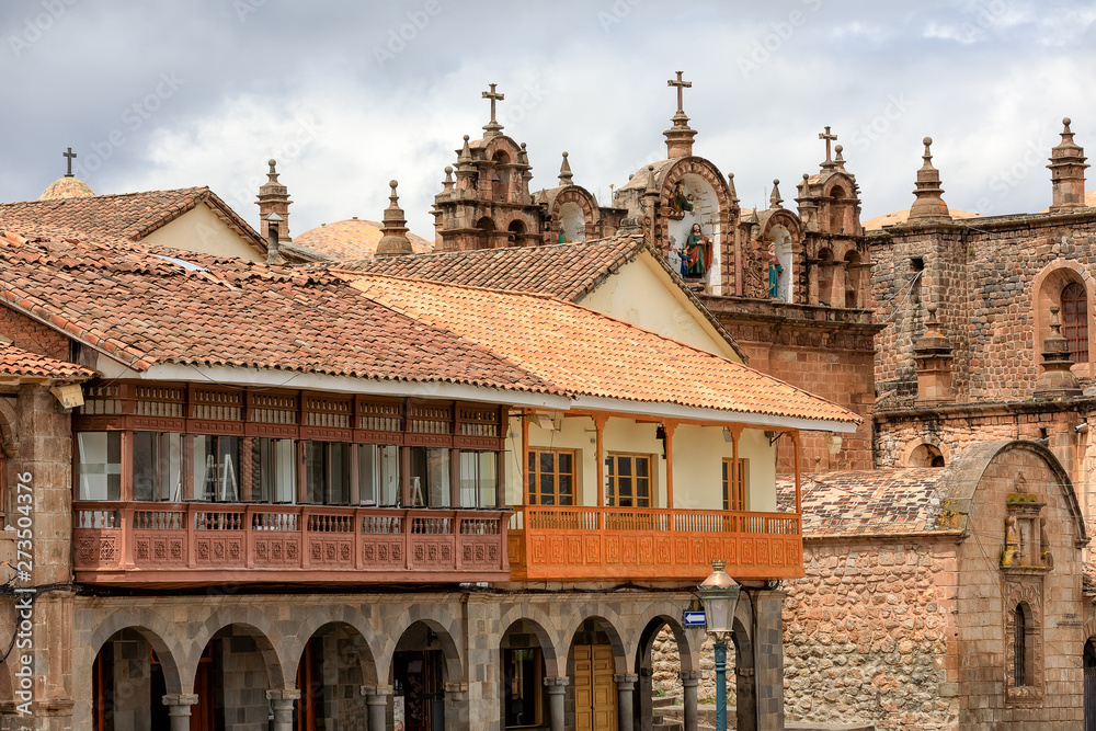 Beautiful authentic old roofs and balconies in historical  Central square of the city - Plaza de Armas in  Cuzco, Peru