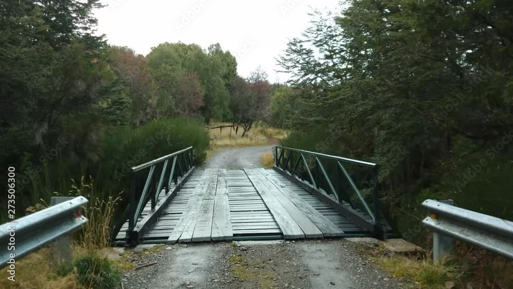 Crossing a wooden bridge in the forest with a river sound as background Crossing a wooden bridge in the forest with a river sound as background