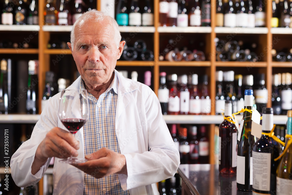 Man owner of winery inviting to tasting wine