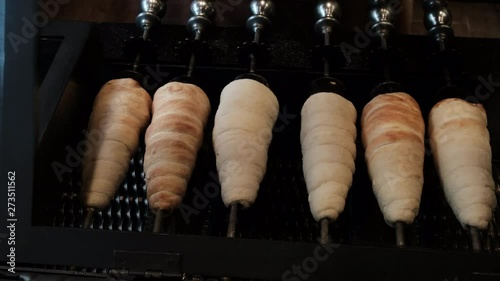 Baking Cooking Trdelnik Spinning On Stick At Food Point In Touristic Walking Street In Prague