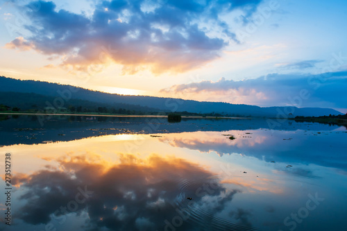 A tranquil lake and dramatic sunset sky.