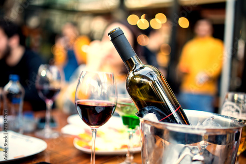 red wine on open air restaurant cafe romantic joyful young adults table