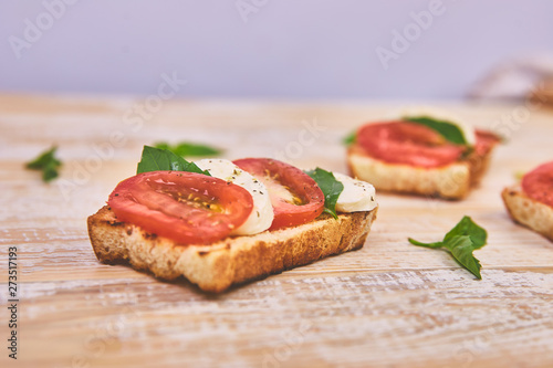 Bruschetta with tomatoes, mozzarella cheese and basil