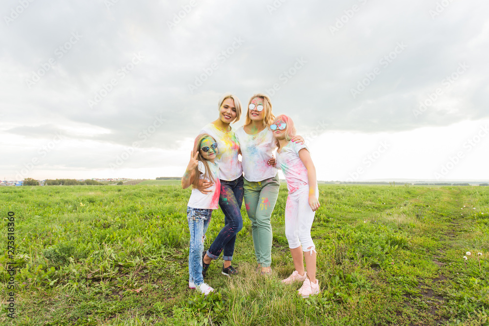 Family, festival of holi and holidays concept - portrait of happy family covered in paint Family, festival of holi and holidays concept - portrait of happy family covered in paint