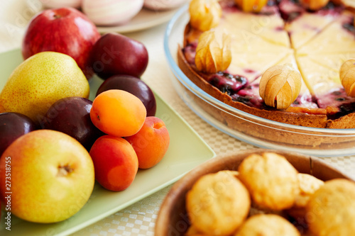 Close-up of holiday table with sweet food and desserts for tea party at home  fresh fruits and delicious cake