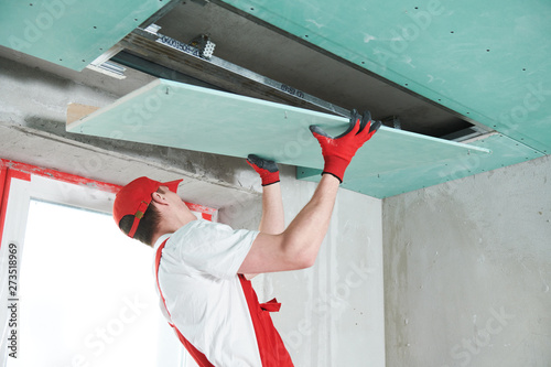 gypsum plasterboard construction work at suspended ceiling photo