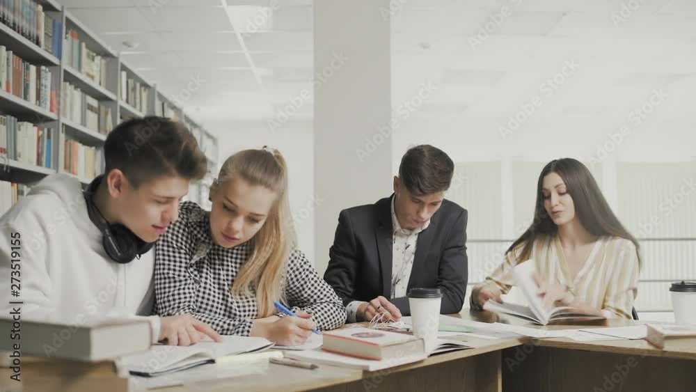 Group of students reading book at school Group of students reading book at school