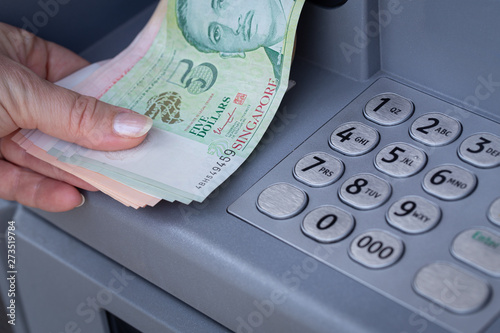 Photography Singapore dollars withdrawn from an ATM