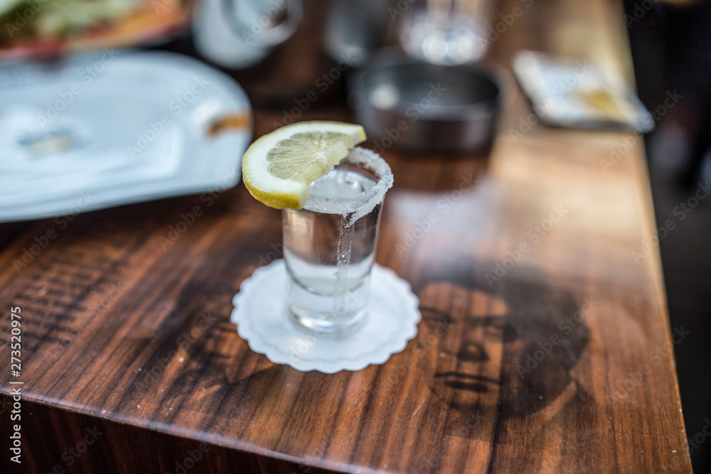 shot glass filled with tequila service with lemon and salt shot glass filled with tequila service with lemon and salt