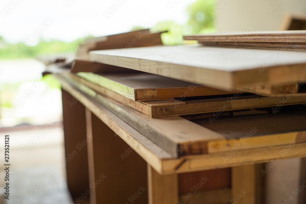 Selective focus on monochrome pile of wooden boards for installing the interior work at the construction site