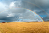 Rainbows and stormy sky over the countryside of Iceland in autumn