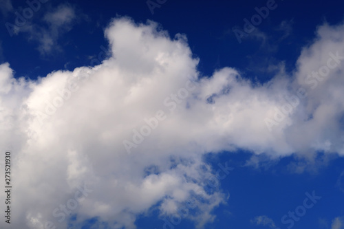 A large cloud spreading across a blue sky