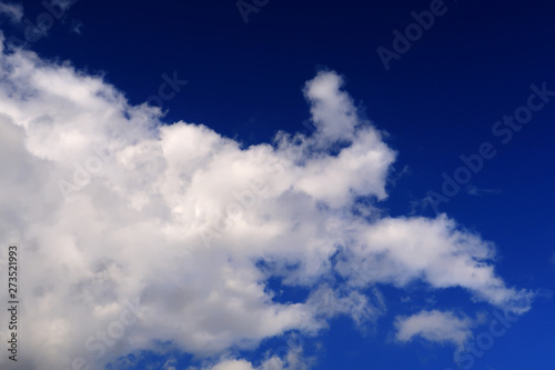 Whispy clouds spreading over a deep blue sky