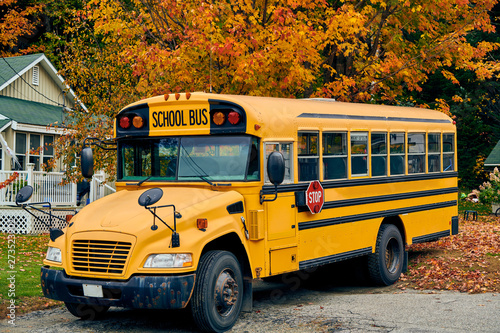 School bus on driveway at autumn, Maine, USA.