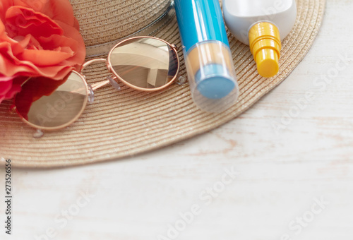 summer layout - hat, sunglasses and sunscreen on colorful background