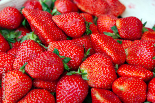 Red ripe, appetizing strawberry closeup as background.