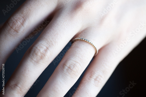 Close up view of woman's hand with wedding ring in sun light