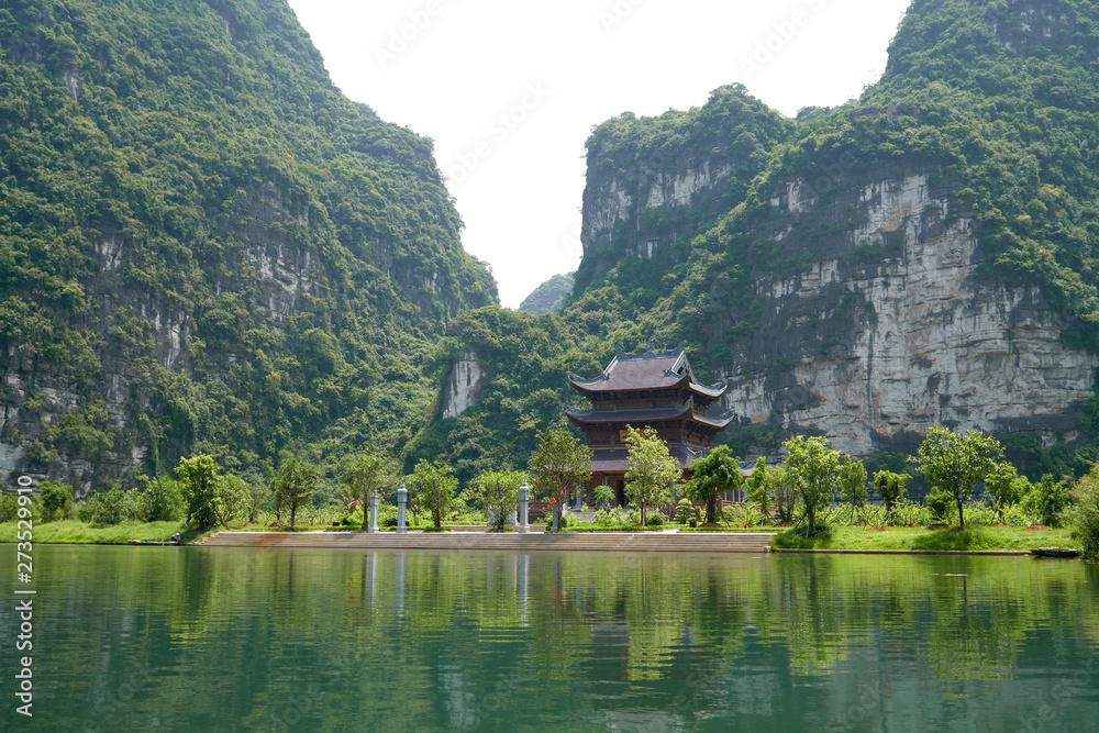 Fototapeta premium Thanh Cao Son temple, landscape and background with a karst mountains, Trang An boat tour in Tam Coc, Vietnam.