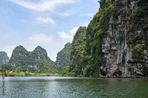 Tam Coc, Trang An river, Ninh Binh, Vietnam. Karst mountains and rocks. Sightseeing boat tour to grottoes and caves. 