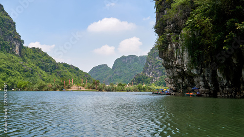 Tam Coc, Trang An river, Ninh Binh, Vietnam. Karst mountains and rocks. Sightseeing boat tour to grottoes and caves. 