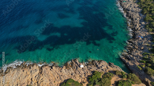Aerial view of small islet of Ydrousa with turquoise and sapphire clear waters and only one mile distance from coast in Voula, Athens riviera, Attica, Greece © aerial-drone