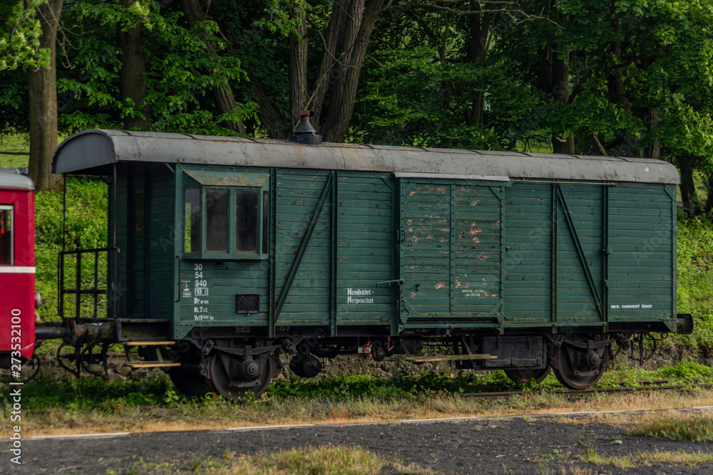 Red old historical diesel train with cargo green car in Ceska Kamenice town Red old historical diesel train with cargo green car in Ceska Kamenice town