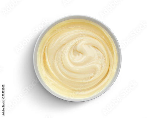 Bowl of condensed milk isolated on white background, top view photo