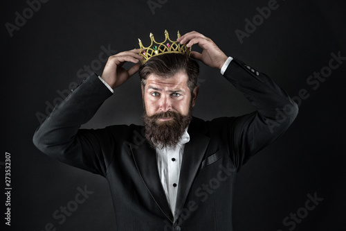 Sense of self importance. Big boss. King crown. Egoist concept. Businessman in tailored tuxedo and crown. Very important person. Important guest luxury party. Top manager. Important person award photo