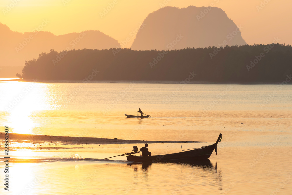 Silhouette photo of fisherman on boat go for fishing in morning in Krabi Thailand