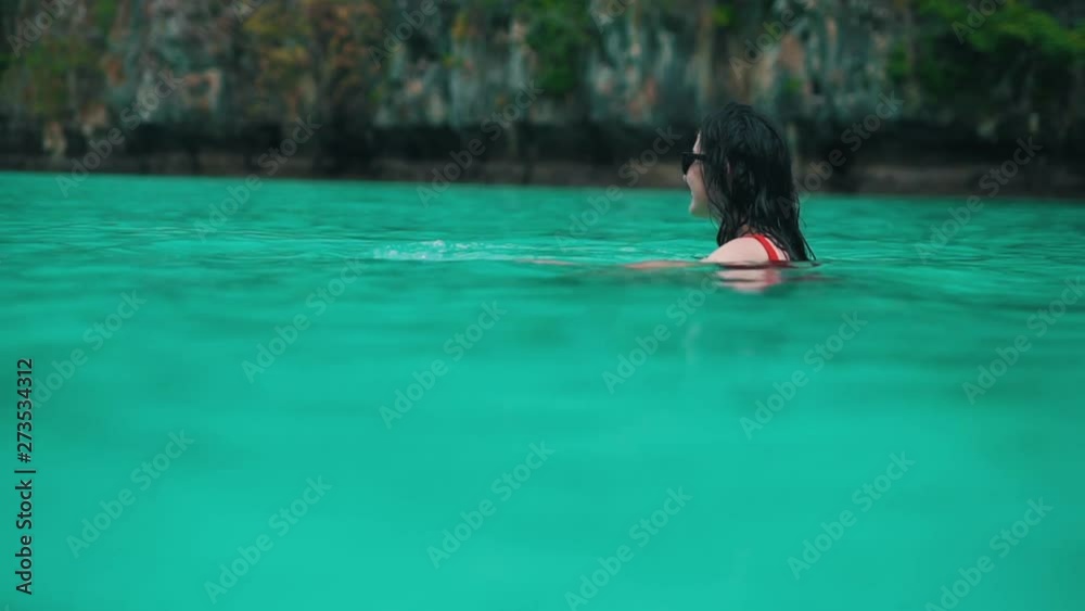 girl has fun in turquoise water girl has fun in turquoise water