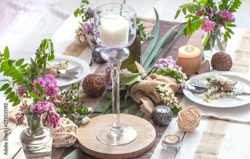 Beautifully elegant decorated table for holiday - wedding or valentine day with modern cutlery  bow  glass  candle and gift