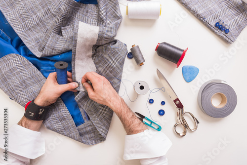 Male tailor hands during man's suit manufacturing