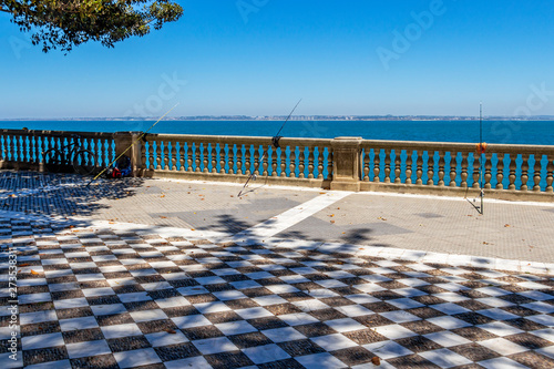 Three fishing rods at the oceanfront promenade of Alameda Apodaca Park in Cadiz  Province of Cadiz  Andalusia  Spain