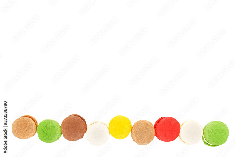 Macarons isolated on white background. Colored macaroons lined up in a row. Top view, save space. Macarons isolated on white background. Colored macaroons lined up in a row. Top view, save space.