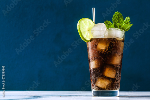 Coca Coke cocktail in a tall glass cuba libre. refreshing summer drink