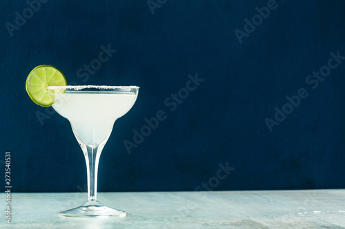 classic margarita cocktail on the table with bar accessories. photo