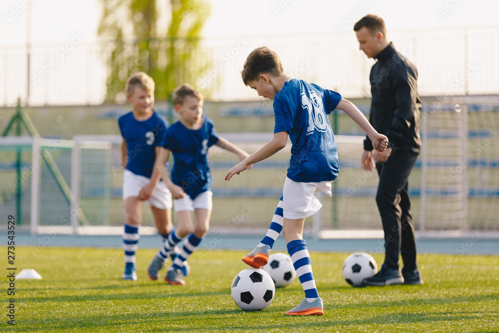 Obraz premium Football Training Practice Exercises for Youth Soccer Players. Boys on Training with Soccer Balls on Pitch