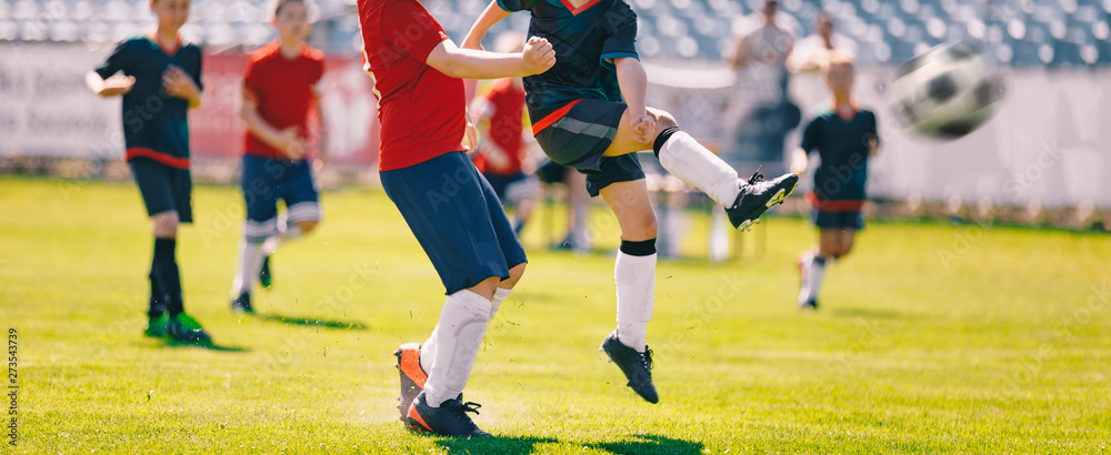 Children Play Soccer Game. Young Boys Running and Kicking Football Ball on Grass Sports Field Children Play Soccer Game. Young Boys Running and Kicking Football Ball on Grass Sports Field