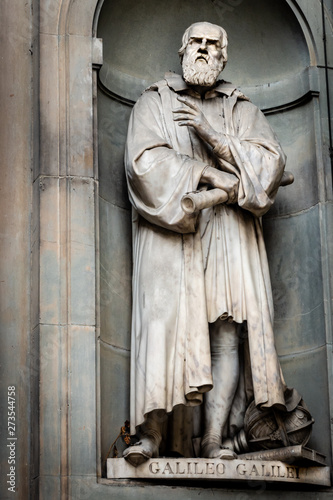 Bild auf Leinwand A statue of Galileo Galilei sitting outside of the Uffizi, in Florence, Italy